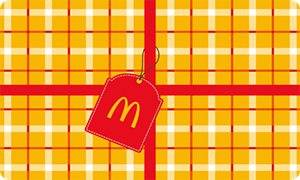 Physical gift card with yellow plaid wrapping paper complete with a ribbon and McDonald’s Arch gift tag
